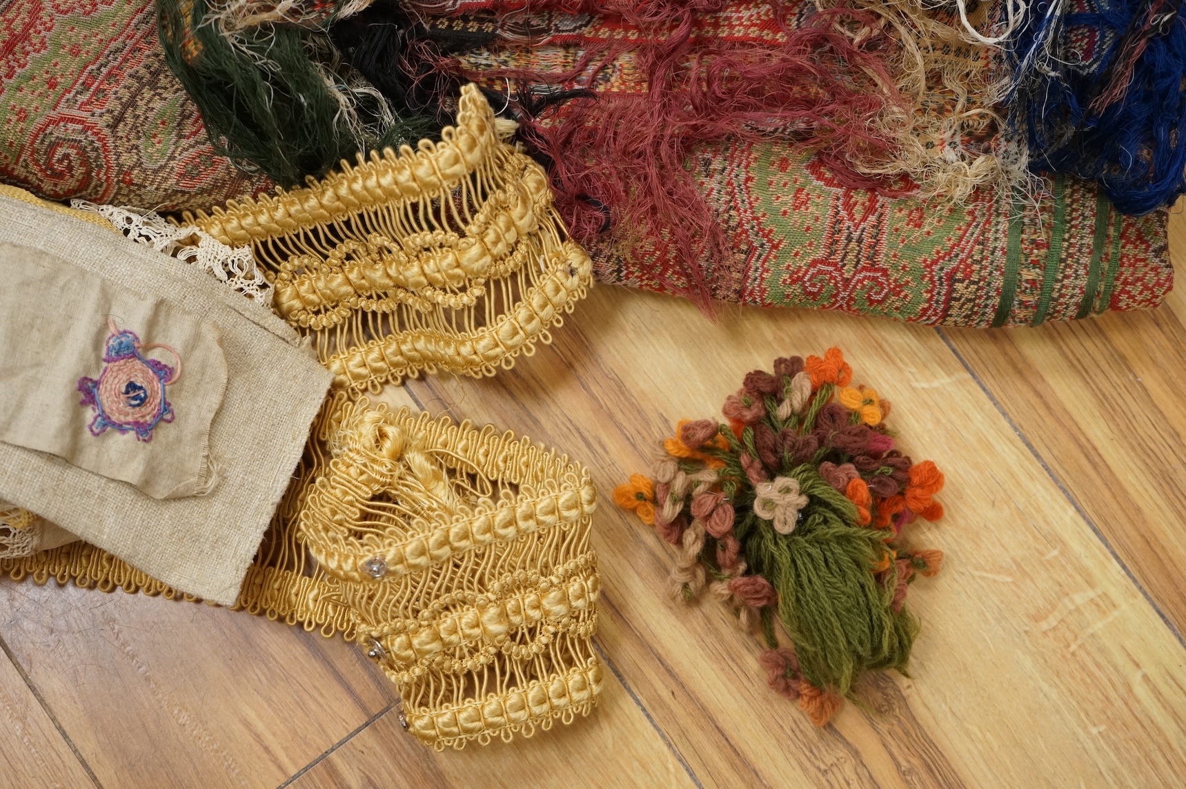 A collection of 19th century fabric and clothing, including a woven Paisley shawl, good for film and TV costume dramas